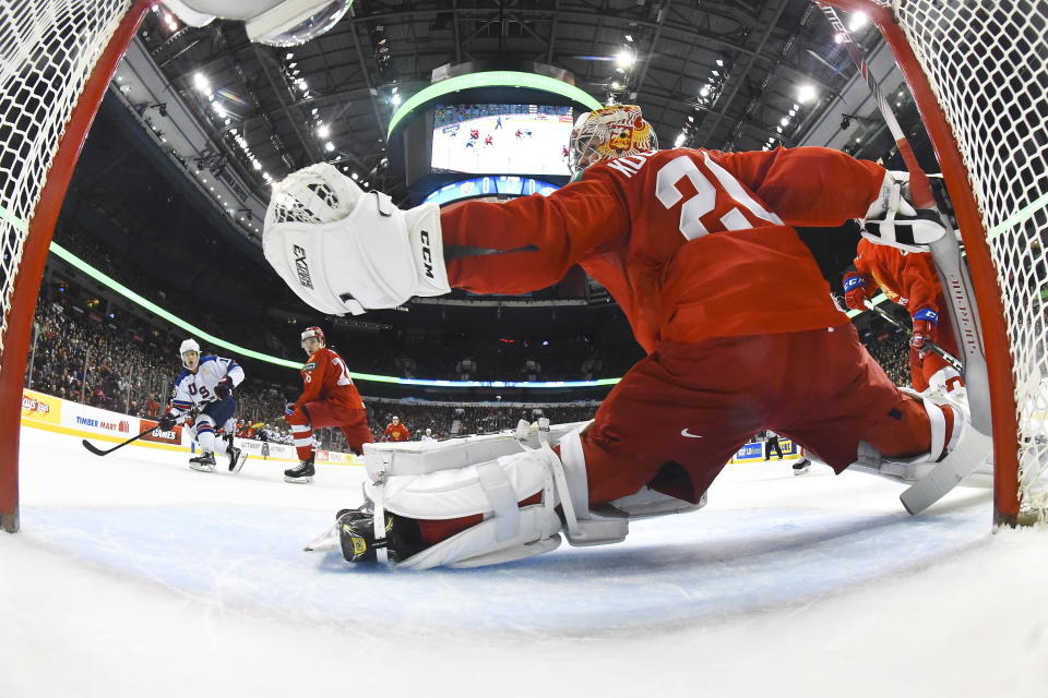 United States' Oliver Wahlstrom (18) scores a first-period goal against Russia goalie Pyotr Kochetkov (20) during a world junior hockey championships semifinal in Vancouver, British Columbia, Friday, Jan. 4, 2019. (Matt Zambonin/Pool Photo via AP)