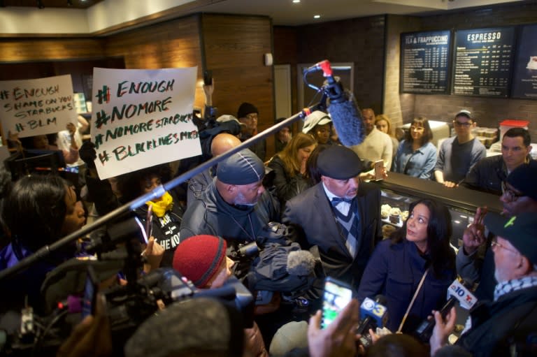 Camille Hymes (C), a Starbucks regional vice-president, addresses media and protestors in a Philadelphia outlet of the coffee chain on April 15, 2018 after the police arrest of two black men sparked outrage and the company apologized