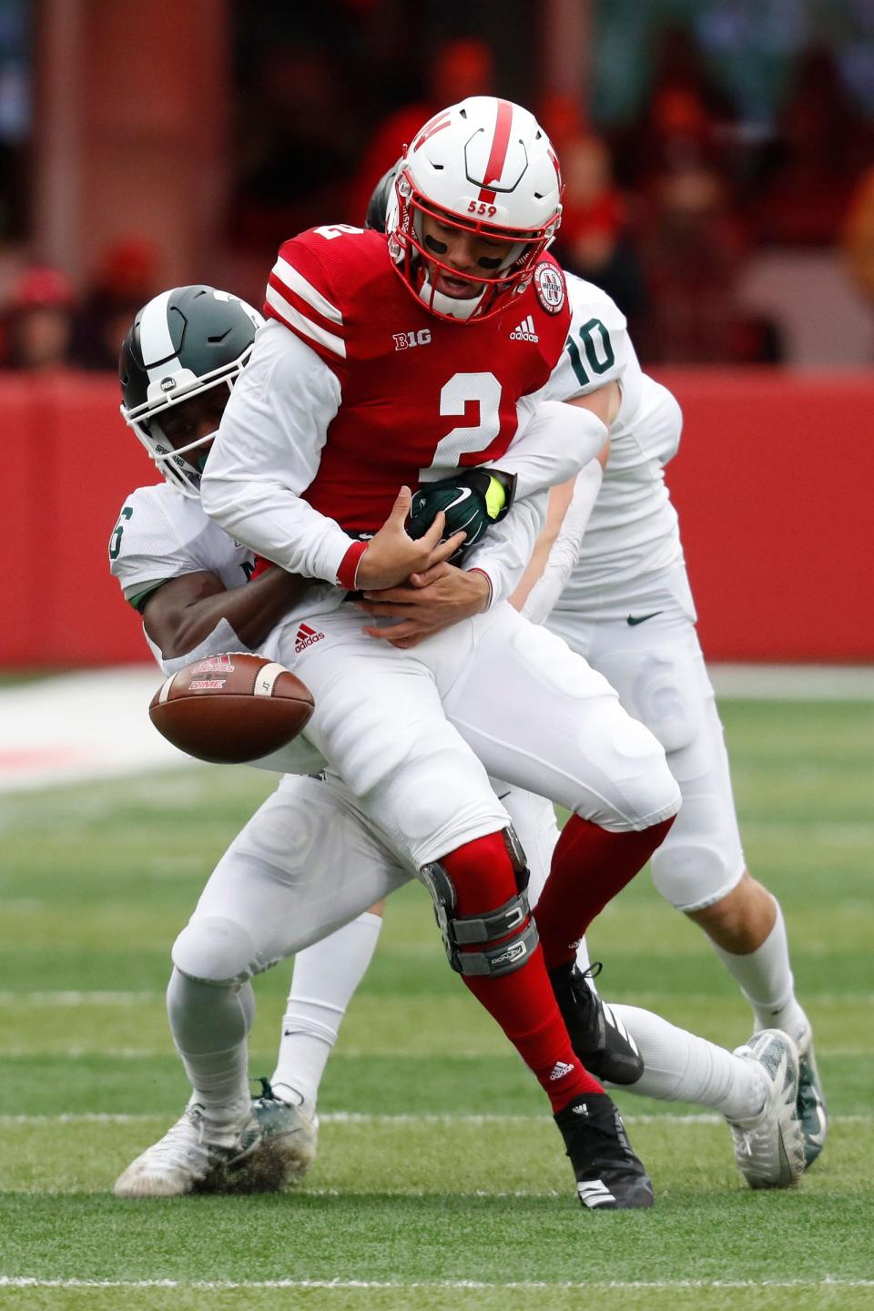 Nebraska quarterback Adrian Martinez fumbles the ball against Michigan State safety David Dowell in the first half at Memorial Stadium.