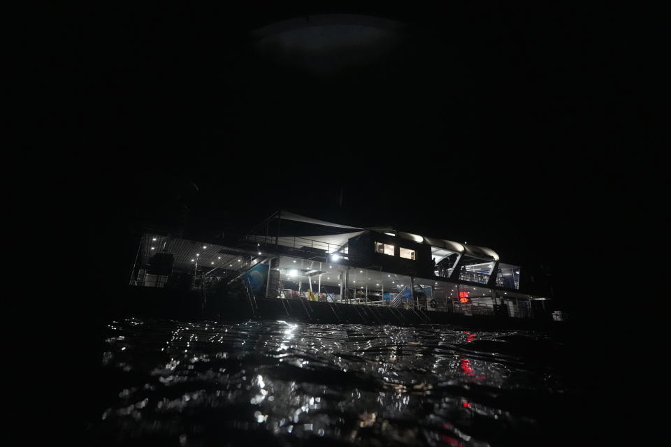 Remoora Pontoon, owned by Reef Magic, floats above Moore Reef in Gunggandji Sea Country off the coast of Queensland in eastern Australia on Nov. 14, 2022. Multiple members of the Yirrganydji and Gunggandji communities are working with government and tour agencies as guides, sea rangers and researchers on reef protection and restoration projects. (AP Photo/Sam McNeil)