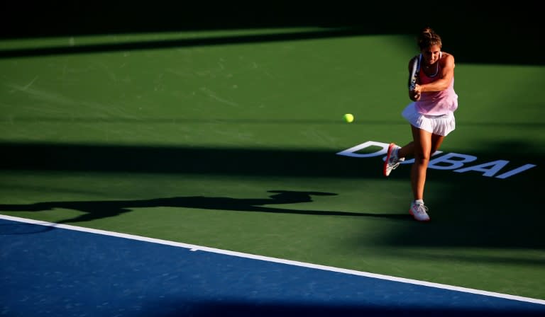 Italian tennis player Sara Errani returns the ball to Madison Brengle of the USA during their quarter final WTA game of the Dubai Duty Free Tennis Championships on February 18, 2016