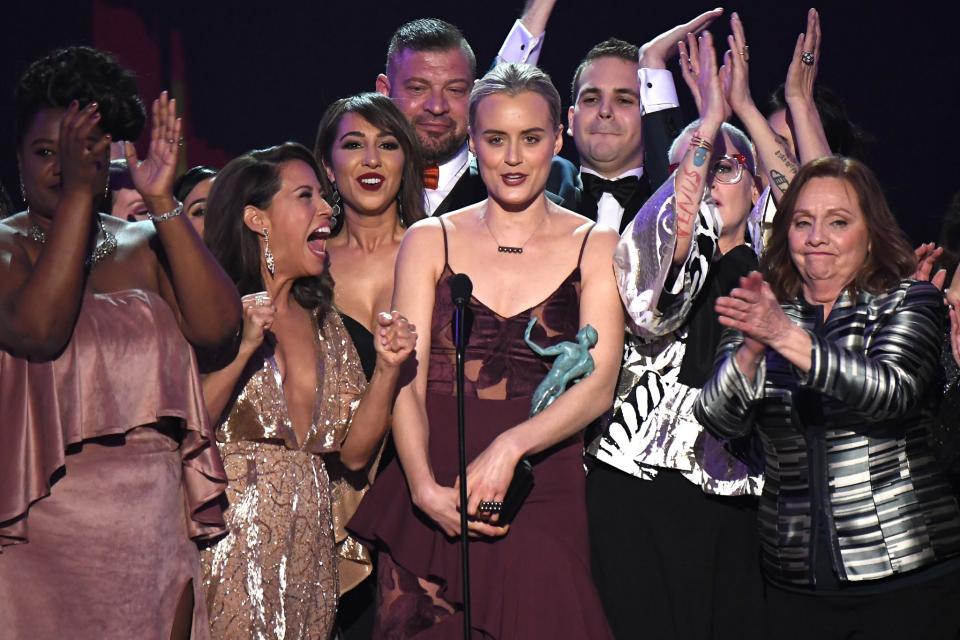 <p>Taylor Schilling accepted an award along with her ‘Orange Is The New Black’ co-stars. She said, “We stand up here representing a diverse group of people, representing generations of families who have sought a better life here.” [Photo: Getty] </p>