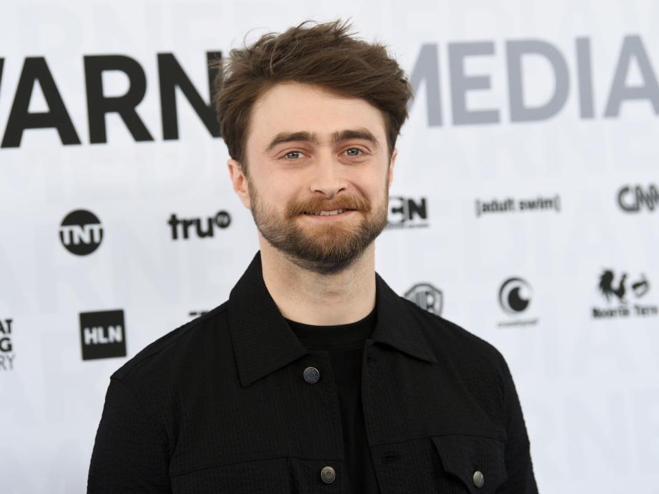 Daniel Radcliffe at an event. He wears a black shirt.
