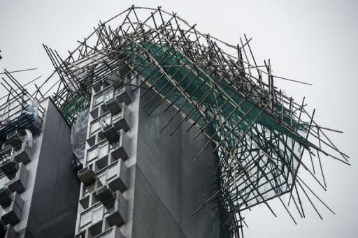 A scaffolding is seen collapsed atop a residential building in the aftermath of Typhoon Vicente in Hong Kong on July 24. Authorities issued a hurricane warning for the first time since 1999 as Typhoon Vicente roared to within 100 kilometres of Hong Kong shortly after midnight