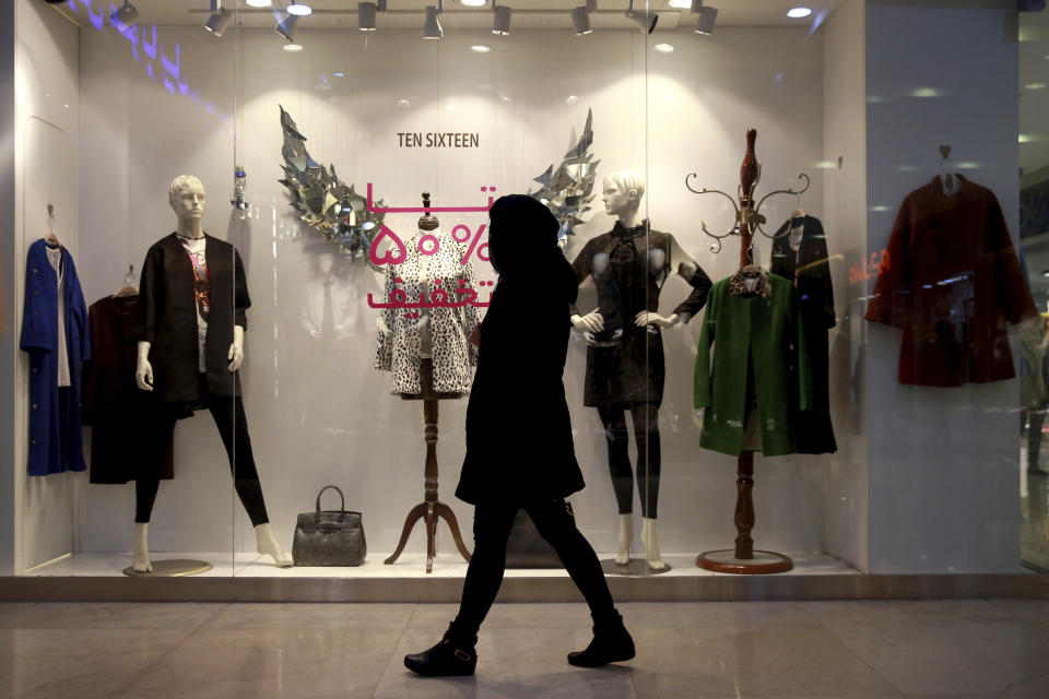 In this Wednesday, Feb. 6, 2019 photo, a woman walks at Kourosh shopping mall, in Tehran, Iran. The economy faces multiple struggles as the country marks the 40th anniversary of the Islamic Revolution. Inflation continues to rise as its currency depreciates and university graduates are unable to find jobs. Some of the challenges stem from the re-imposition of U.S. sanctions while other problems date back to the time of the revolution. (AP Photo/Vahid Salemi)