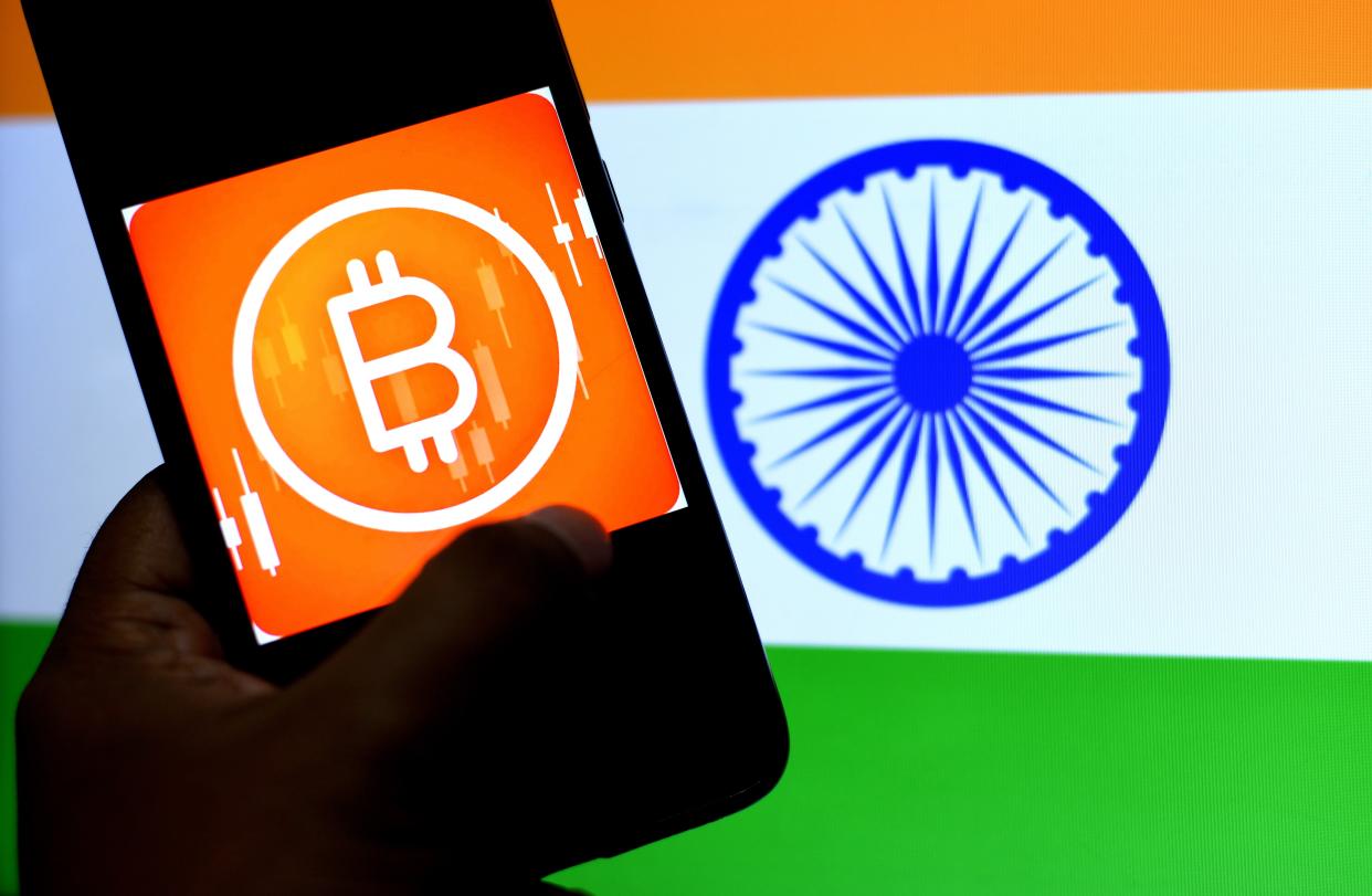 INDIA - 2021/02/01: In this Photo illustration a Bitcoin logo seen displayed on a smartphone with an Indian flag in the background. (Photo Illustration by Avishek Das/SOPA Images/LightRocket via Getty Images)