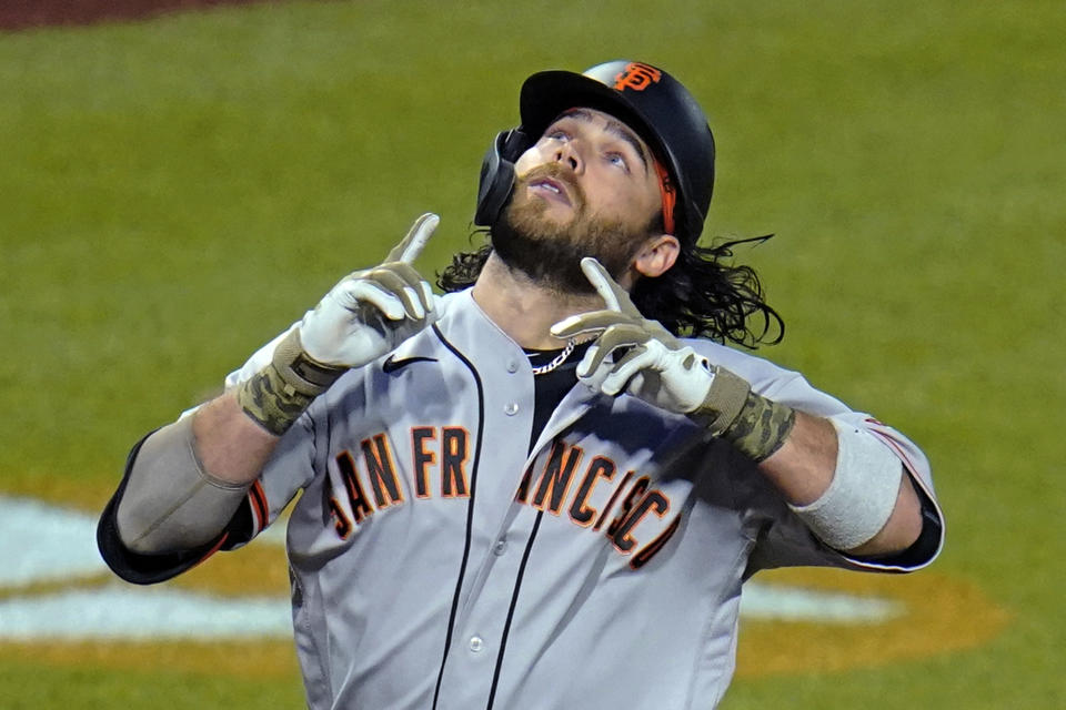 San Francisco Giants' Brandon Crawford celebrates as he crosses home plate on a solo home run off Pittsburgh Pirates relief pitcher Duane Underwood Jr. during the eighth inning of a baseball game in Pittsburgh, Friday, May 14, 2021. (AP Photo/Gene J. Puskar)