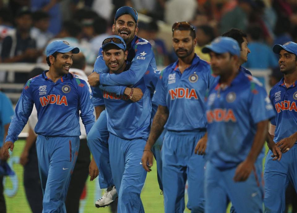 India's Yuvraj Singh, second left, carries teammate Virat Kohli on his back as they celebrate their win over Australia in their ICC Twenty20 Cricket World Cup match in Dhaka, Bangladesh, Sunday, March 30, 2014. India won the match by 73 runs. (AP Photo/Aijaz Rahi)
