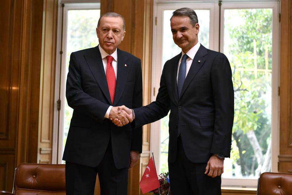 Greece's Prime Minister Kyriakos Mitsotakis, right, shakes hands with Turkey's President Recep Tayyip Erdogan at Maximos Mansion in Athens, Greece, Thursday, Dec. 7, 2023. Erdogan arrived in Greece on a visit designed to set the historically uneasy neighbors on a more constructive path and help repair strained his country's strained relationship with the European Union. (AP Photo/Michael Varaklas)