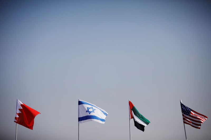 FILE PHOTO: The flags of the U.S., United Arab Emirates, Israel and Bahrain flutter along a road in Netanya