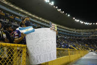 A fan holds up a sign before a qualifying soccer match between El Salvador and United States for the FIFA World Cup Qatar 2022 at Cuscatlan stadium in San Salvador, El Salvador, Thursday, Sept. 2, 2021. (AP Photo/Moises Castillo)