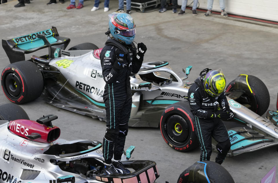 Mercedes driver George Russell, of Britain, left, celebrates winning the Sprint Race qualifying session at the Interlagos racetrack, in Sao Paulo, Brazil, Saturday, Nov. 12, 2022. The Brazilian Formula One Grand Prix will take place on Sunday. (AP Photo/Andre Penner)