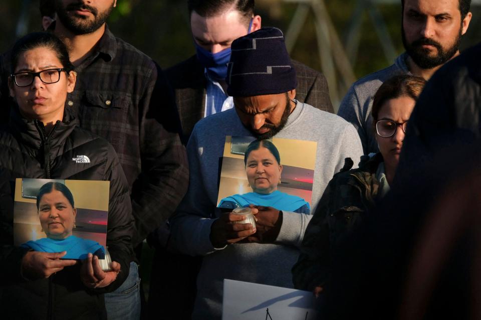 Image: Family members hold a photo of their loved one during a candlelight vigil in Krannert Park in Indianapolis on April 17, 2021, to remember the victims of a mass shooting at a FedEx facility. (Jeff Dean / AFP - Getty Images)