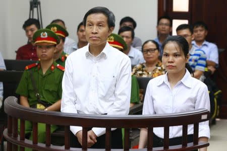 Vietnamese prominent blogger Anh Ba Sam whose real name is Nguyen Huu Vinh (L) and his assistant Nguyen Thi Minh Thuy stand at dock during their appeal trial in Hanoi, Vietnam September 22, 2016. Mandatory credit VNA/Doan Tan/via