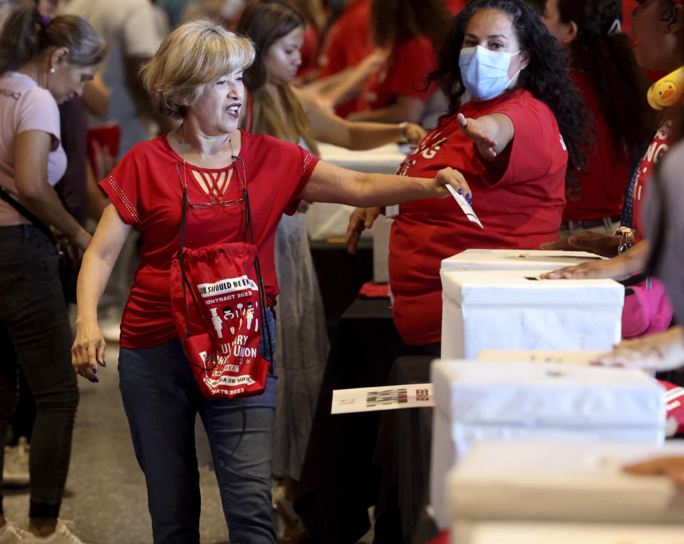 Culinary Union members, including Rio team member Elvira Bahena, cast their ballots during a strike vote, Tuesday, Sept. 26, 2023, at Thomas & Mack Center on the UNLV campus in Las Vegas. Tens of thousands of hospitality workers who keep the iconic casinos and hotels of Las Vegas humming were set to vote Tuesday on whether to authorize a strike amid ongoing contract negotiations. (K.M. Cannon/Las Vegas Review-Journal via AP)