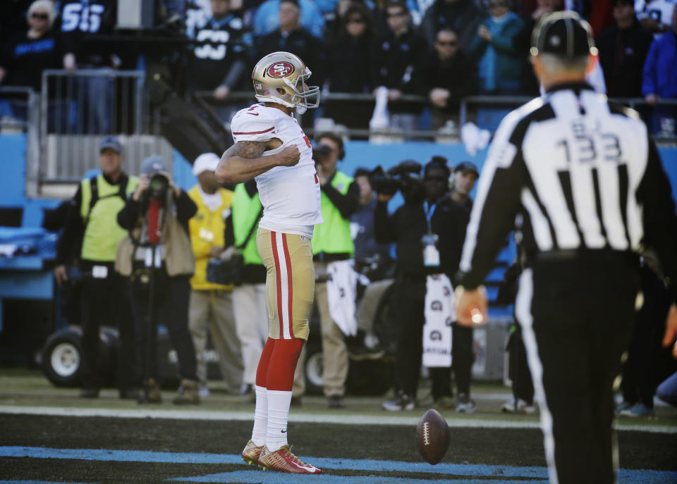 San Francisco 49ers quarterback Colin Kaepernick (7) celebrates after scoring a touchdown against the Carolina Panthers during the second half of a divisional playoff NFL football game, Sunday, Jan. 12, 2014, in Charlotte, N.C. (AP Photo/John Bazemore)