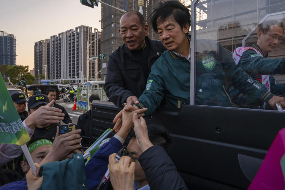 FILE - Taiwan Democratic Progressive Party (DPP) presidential candidate Lai Ching-te, who also goes by William, is greeted by supporters during an election canvass of a neighborhood in Taoyuan, Taiwan, Jan. 11, 2024, ahead of the presidential election. Lai Ching-te is set to take office as Taiwan's new president on May 20. Building on the legacy of incumbent president Tsai, Ing-wen means aiming to strike a balance between cultivating Taiwan's unofficial alliance with the United States, and maintaining peace with China, which claims Taiwan as its own territory, to be retaken by force if necessary. (AP Photo/Louise Delmotte, File)