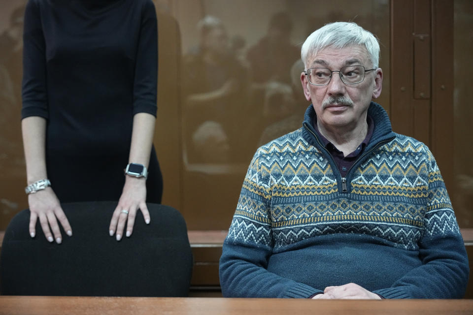 The co-chair of Nobel Peace Prize winning Memorial Human Rights Centre Oleg Orlov sits in a courtroom prior to a court session for a new trial on charges of repeated discrediting Russian military, in Moscow, Russia, on Tuesday, Feb. 27, 2024. (AP Photo/Alexander Zemlianichenko)