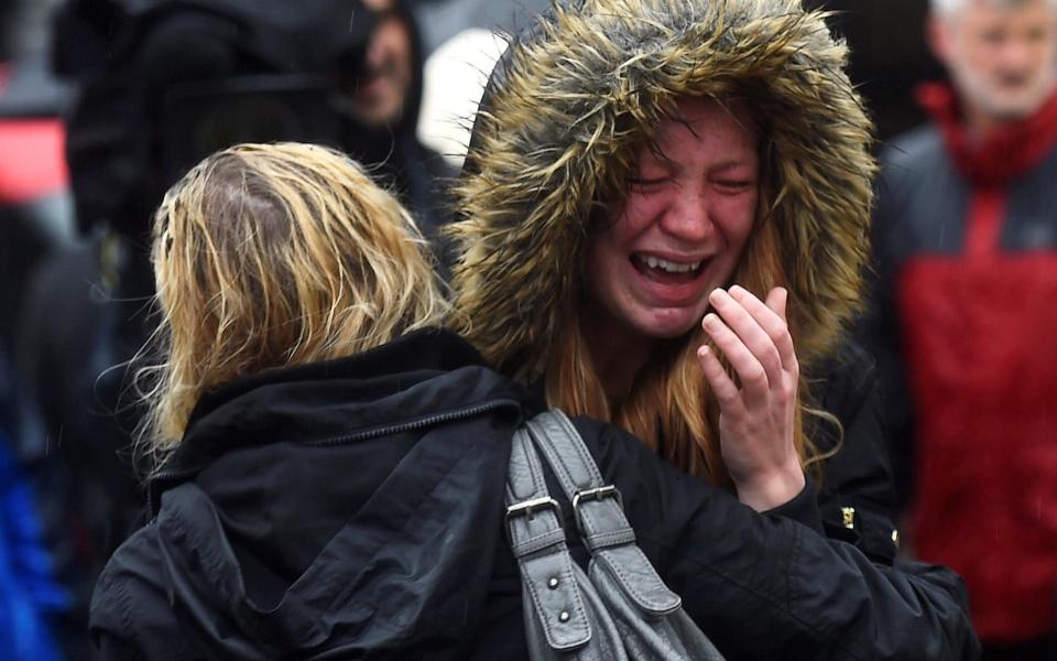 A woman reacts during a minute's silence held for the victims of the attack on London Bridge and Borough Market - Credit: REUTERS/Clodagh Kilcoyne