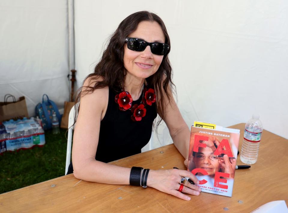 <div class="inline-image__caption"><p>Justine Bateman holds a copy of her book at the Los Angeles Times Festival of Books on April 24, 2022.</p></div> <div class="inline-image__credit">David Livingston</div>