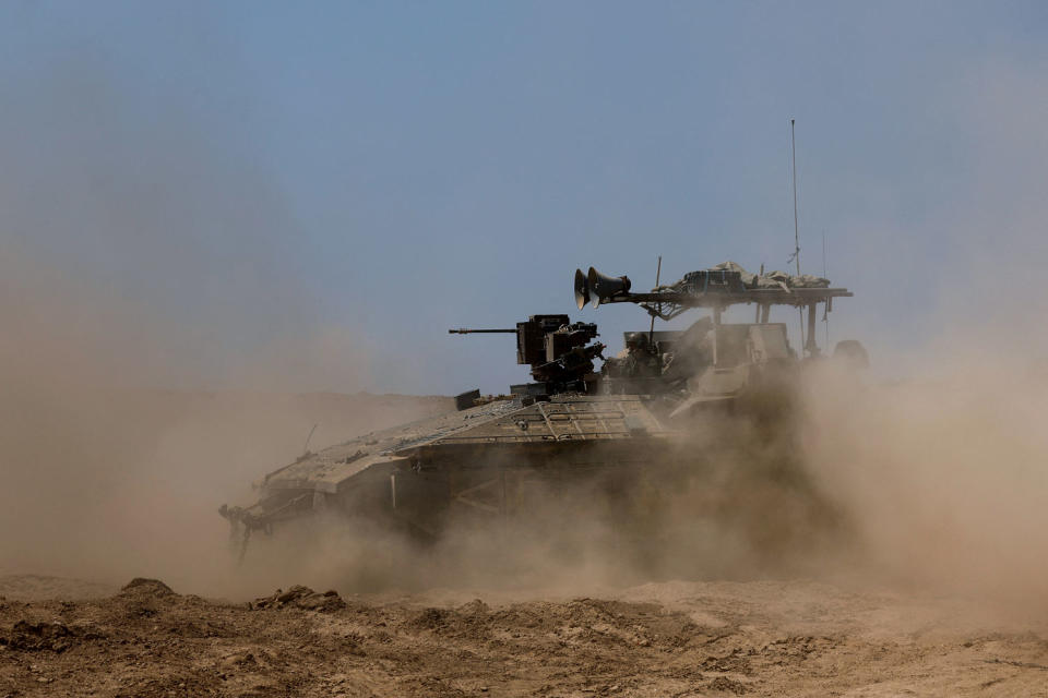 Israeli military vehicles manoeuvre, near the Israel-Gaza border (Amir Cohen / Reuters)