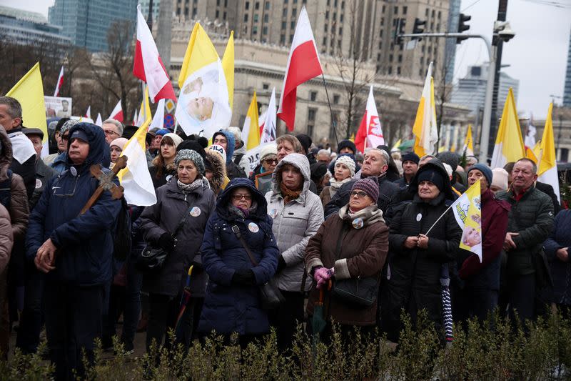 People march in defense of pope John Paul II on his death anniversary in Warsaw