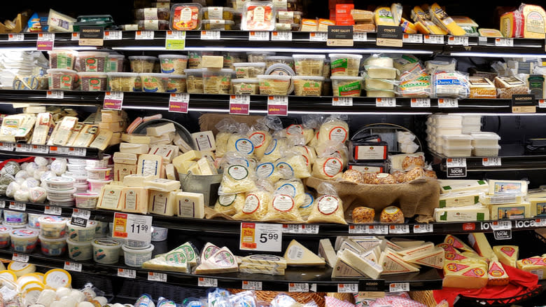 Grocery store display of refrigerated cheeses