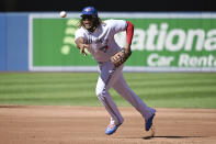 Toronto Blue Jays' Vladimir Guerrero Jr. tosses the ball to pitcher Jose Berrios at first base in the second inning of a baseball game against the Minnesota Twins in Toronto on Sunday, Sept. 19, 2021. Berrios mishandled the throw and Minnesota Twins' Nick Gordon was safe at first base. (Jon Blacker/The Canadian Press via AP)