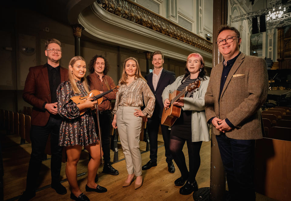 Far left, Ciaran Scullion from the Arts Council of Northern Ireland and, far right, Richard Yarr from BBC Northern Ireland join some of the young musicians (Arts Council NI/PA)