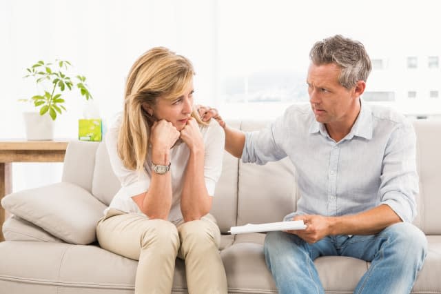 Concerned therapist comforting female patient in the office