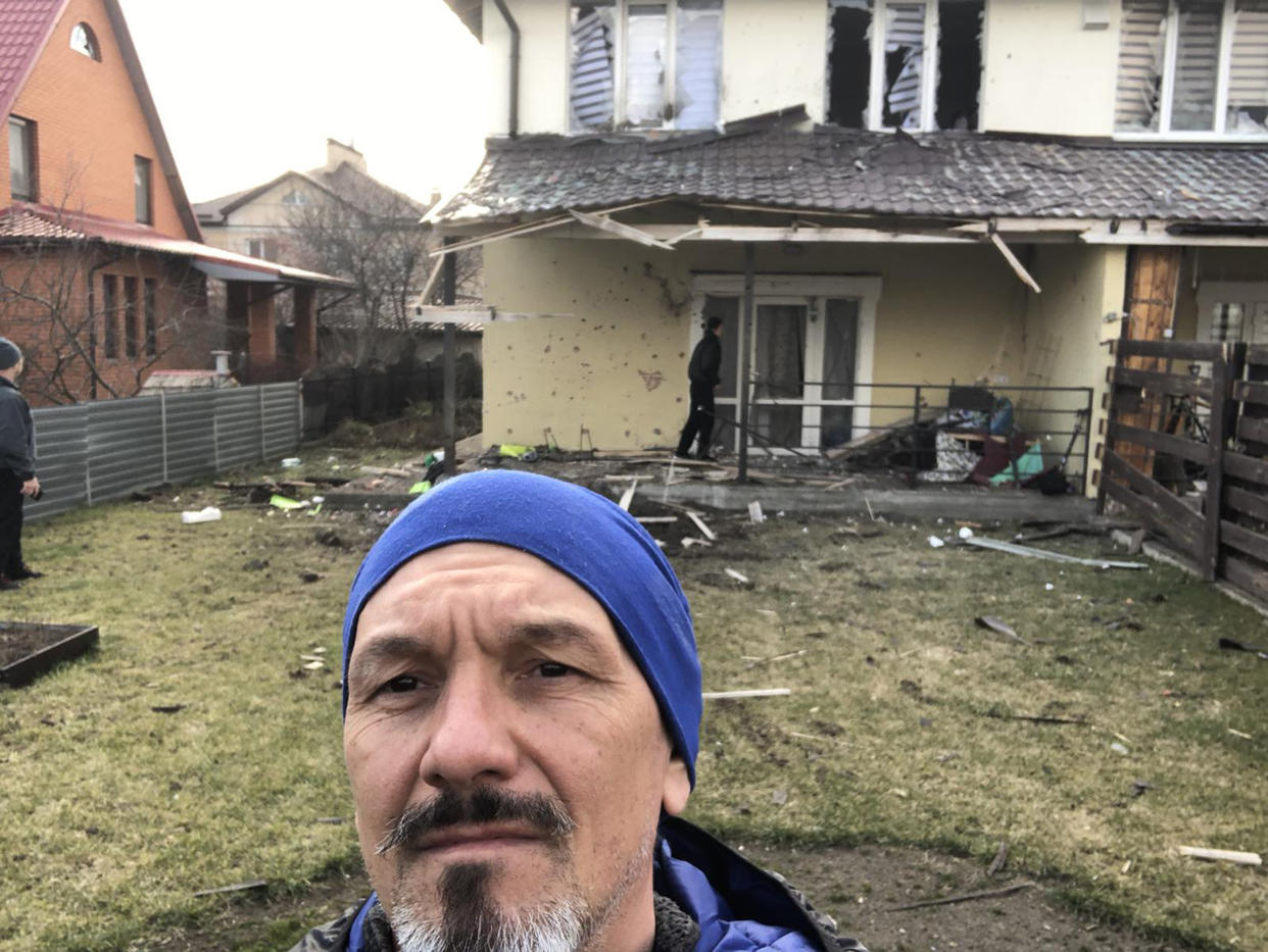 Roman Vlasenko in front of his family home in Vorzel after it was bombed. (Courtesy Roman Vlasenko)