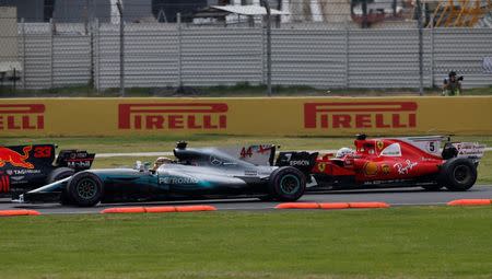 FILE PHOTO - F1 - Formula 1 - Mexican Grand Prix 2017 - Mexico City, Mexico - October 29, 2017 Ferrari's Sebastian Vettel and Mercedes' Lewis Hamilton at the start of the race REUTERS/Henry Romero