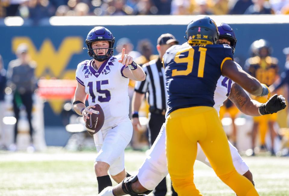 TCU quarterback Max Duggan (15) rolls out to pass during the second quarter against West Virginia at Mountaineer Field at Milan Puskar Stadium.