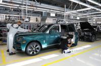 Technicians inspect a Rolls-Royce a car on the production line of the Rolls-Royce Goodwood factory, near Chichester