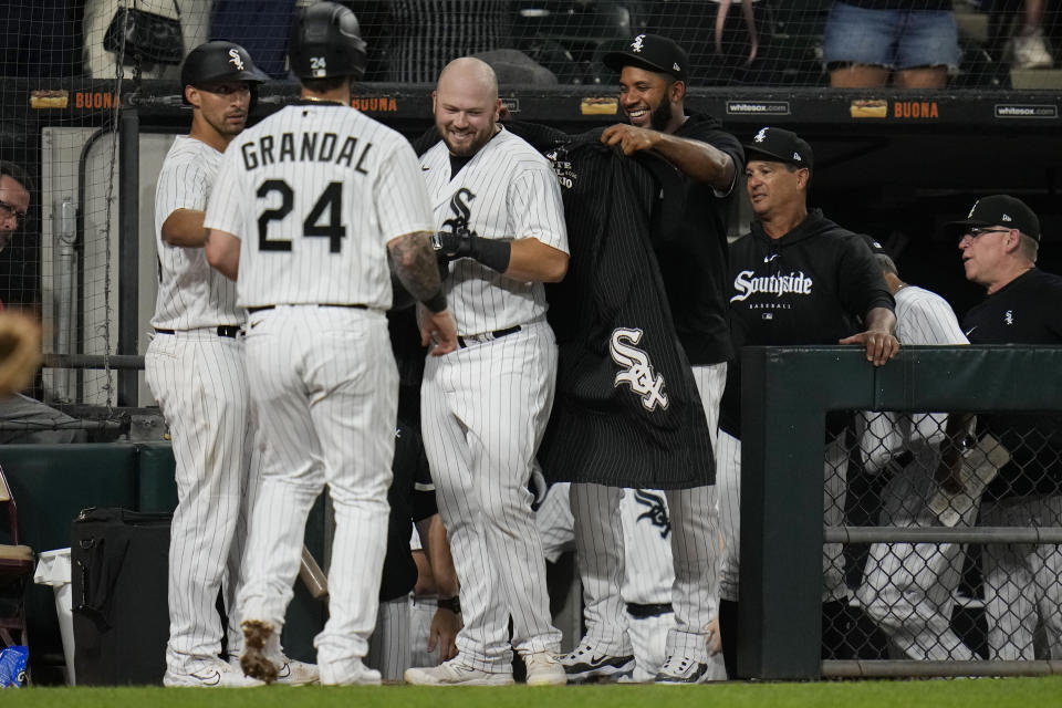 Chicago White Sox's Elvis Andrus, right, puts the home run cape onto Jake Burger after Burger hit a two-run home run against the Cleveland Guardians during the fifth inning of a baseball game Thursday, July 27, 2023, in Chicago. (AP Photo/Erin Hooley)