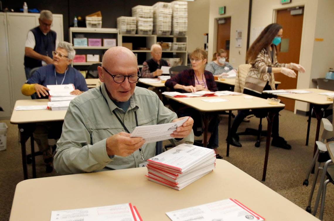 Buzz Kalkowski and other San Luis Obispo County Elections Office workers process vote-by-mail ballots on Nov. 9, 2022, the day after the vote.
