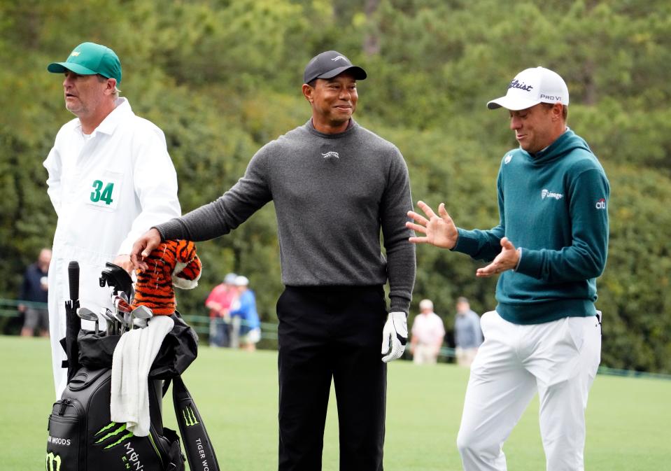 Apr 9, 2024; Augusta, Georgia, USA; Tiger Woods and Justin Thomas chat as they walk down the no. 1 fairway during a practice round for the Masters Tournament golf tournament at Augusta National Golf Club. Mandatory Credit: Rob Schumacher-USA TODAY Sports