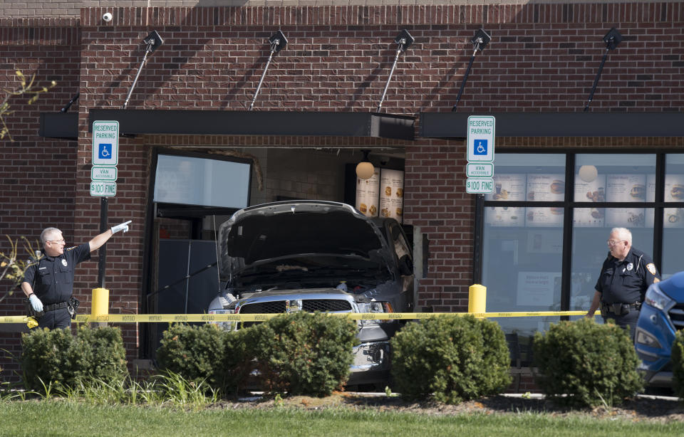 Lincoln Police Department investigates the scene of a shooting at a Chick-fil-A restaurant Tuesday, Oct. 8, 2019 in Lincoln, Neb. A uniformed railroad officer fatally shot a disgruntled customer who rammed his truck into restaurant police said Tuesday. (Gwyneth Roberts/Lincoln Journal Star via AP)