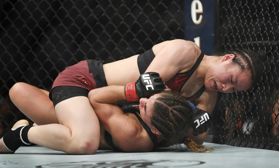 Mar 2, 2019; Las Vegas, NV, USA; Tecia Torres (red gloves) and Weili Zhang (blue gloves) during UFC 235 at T-Mobile Arena. Mandatory Credit: Stephen R. Sylvanie-USA TODAY Sports