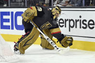 Vegas Golden Knights goaltender Marc-Andre Fleury (29) handles the puck behind the net against the Minnesota Wild during the third period of Game 1 of a first-round NHL hockey playoff series Sunday, May 16, 2021, in Las Vegas. (AP Photo/David Becker)