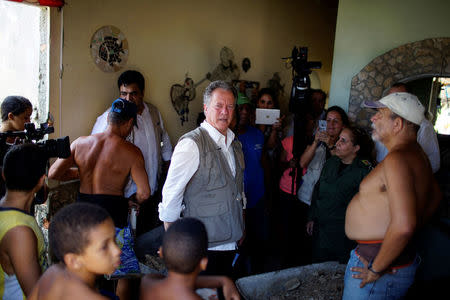Executive Director of the U.N. World Food Programme David Beasley (C), walks inside a damaged house due to Hurricane Irma during a visit to Havana, Cuba, September 16, 2017. REUTERS/Alexandre Meneghini