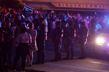 Protesters are blocked by police as they attempt to walk down a ramp to Interstate 64 after the not guilty verdict in the murder trial of Jason Stockley, a former St. Louis police officer, charged with the 2011 shooting of Anthony Lamar Smith, who was black, in St. Louis, Missouri, U.S., September 15, 2017. REUTERS/Whitney Curtis