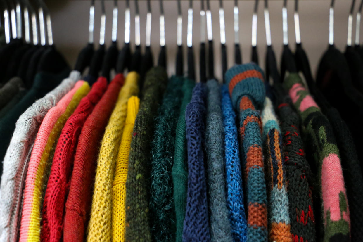 Sweaters hung up in a closet