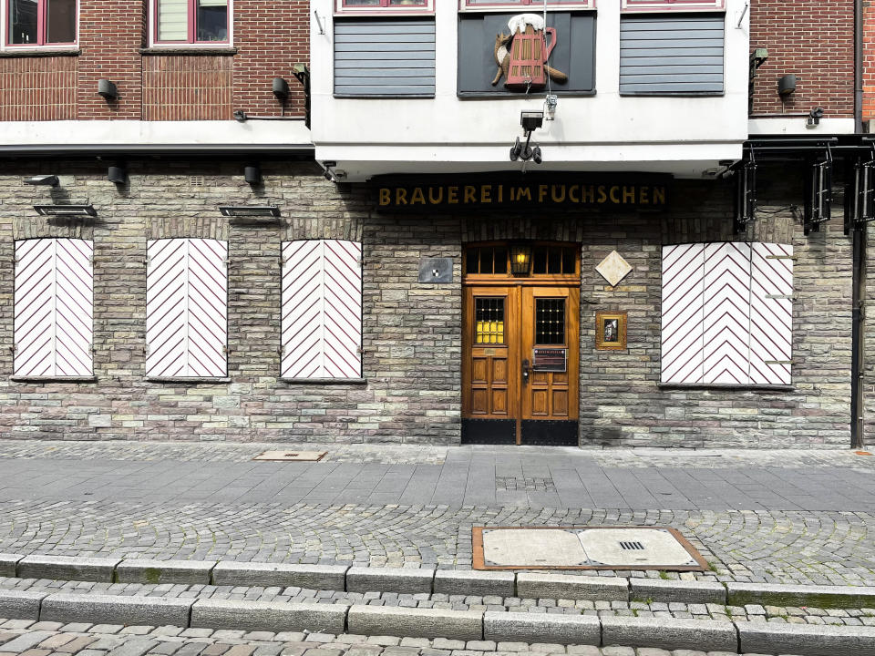 The restaurant of the Fuechschen brewery is closed in Duesseldorf, Germany, Tuesday, March 23, 2021, where about 6,000 litres of its renowned copper-colored 'Altbier' remain unsold and nearing its expiry date. The brewery now works with craft bakers who use the beer to make bread, with about twelve bakeries producing the grain bread and are giving the additional bonus of a bottle of Fuechschen's Altbier free of charge with every loaf.(AP Photo/Daniel Niemann)