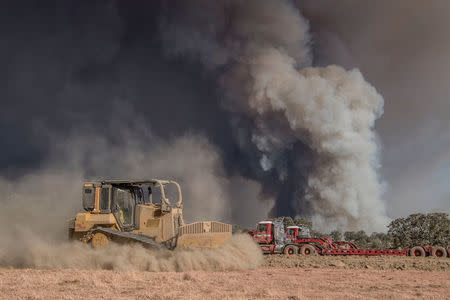 A Cal Fire bulldozer makes a safety zone on Shilling Ranch after authorities ordered evacuations due to the Detwiler fire in Mariposa, California, U.S. July 18, 2017. REUTERS/Al Golub