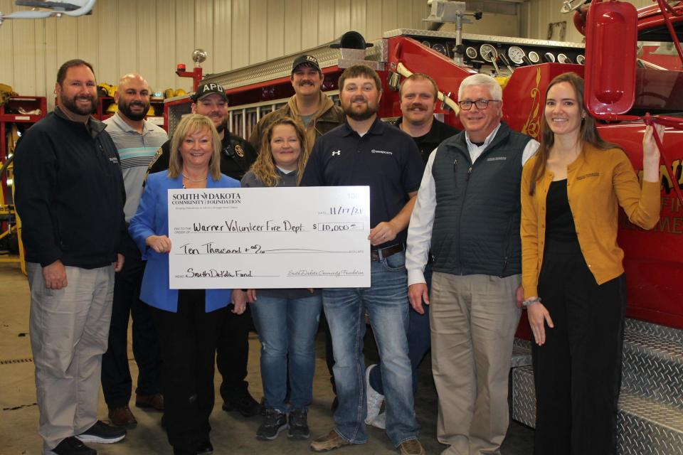 South Dakota Community Foundation Senior Program Officer Ginger Niemann, front left, Community Development Coordinator Patrick Gallagher, second from right, and Grant Program Coordinator Crystal Ortbahn, far right, are joined by Warner Volunteer Fire Department members who secured a $10,000 South Dakota Fund grant award. The grant will partially support the purchase of updated gear for their new members. The Warner Volunteer Fire Department is mostly comprised of farmers, teachers, and bankers in the area.