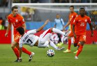 Costa Rica's Christian Bolanos (C) fights for the ball with Stefan de Vrij (L) and Georginio Wijnaldum of the Netherlands during their 2014 World Cup quarter-finals at the Fonte Nova arena in Salvador July 5, 2014. REUTERS/Paul Hanna