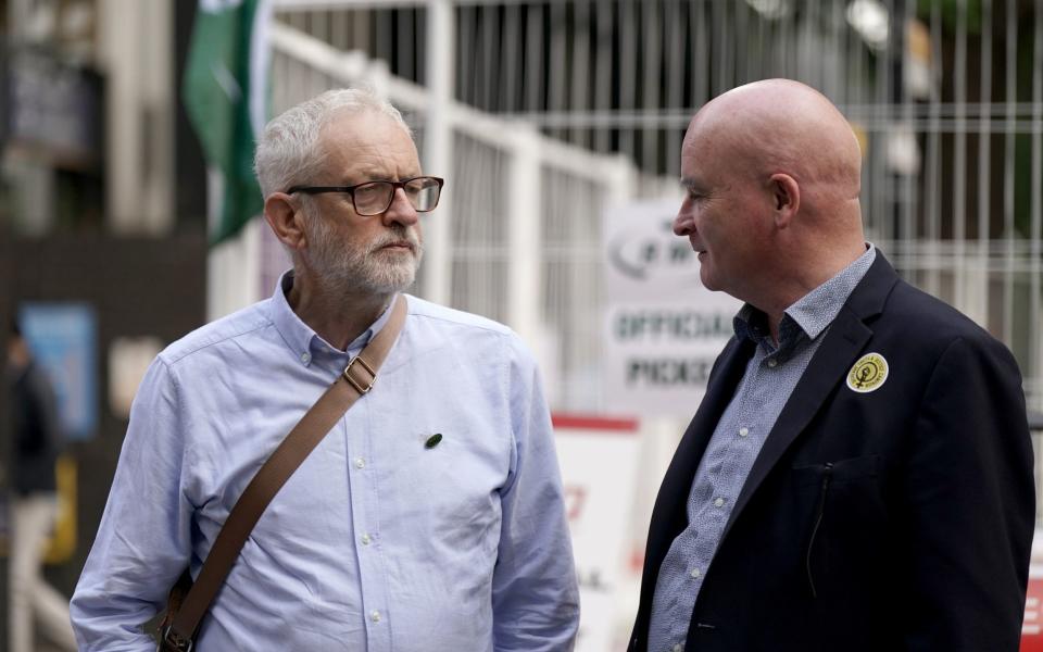 Rail, Maritime and Transport union (RMT) General Secretary Mick Lynch (right) and Jeremy Corbyn are pictured outside London Euston train station this morning as RMT union members take part in a fresh strike over jobs, pay and conditions - Aaron Chown/PA