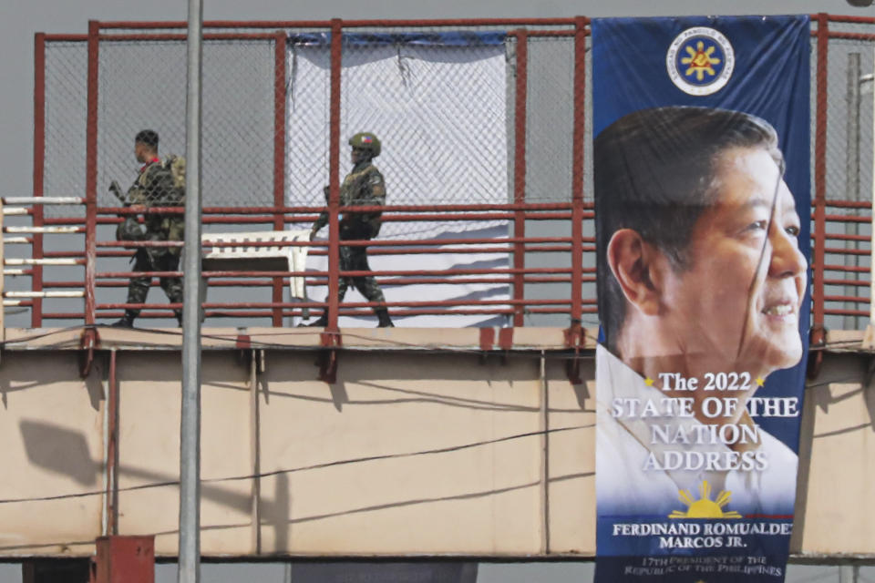 Special Action Forces (SAF) secure the main road and footbridges along the main road leading to the House of Representatives Congress in Quezon City, Philippines ahead of the State of the Nation address Monday, July 25, 2022. Philippine President Ferdinand Marcos Jr. will deliver his first State of the Nation address Monday with momentum from his landslide election victory, but he's hamstrung by history as an ousted dictator’s son and daunting economic headwinds. (AP Photo/Gerard Carreon)