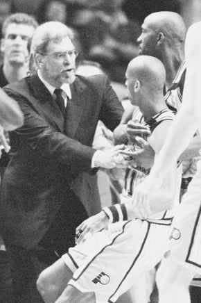 Chicago coach Phil Jackson pushes Indiana's Reggie Miller away from the Bulls' bench after a minor scuffle between Miller and the Bulls' Ron Harper.